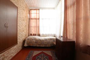 a small bedroom with a bed and a window at Guesthouse ''Ashot Shalunts'' in Goris