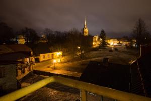 a view of a city at night with a church at Hotel Katrina in Cēsis