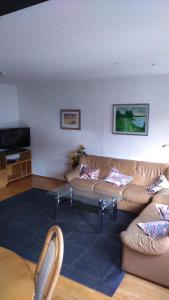 a living room with two couches and a tv at Ferienwohnung St. Wigbert in Fritzlar
