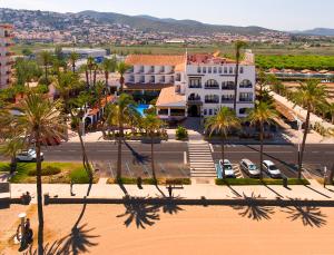 an aerial view of a town with palm trees and a building at Hostería del Mar in Peñíscola