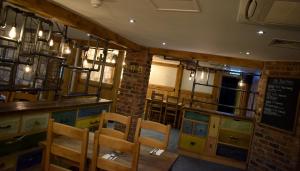 a living room filled with furniture and a large window at The Horse & Jockey in Alfreton