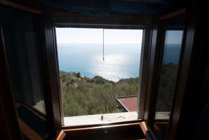 a view of the ocean from a window at Il Sole di Valletonda Holiday House in Corniglia