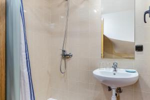 a bathroom with a shower, sink, and toilet at Apartamentos Prat de les Molleres in Soldeu
