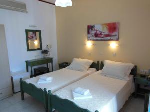 Ένα ή περισσότερα κρεβάτια σε δωμάτιο στο Poseidon Hotel 