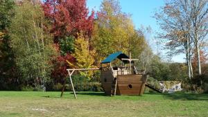 a wooden playground in a park with a slide at Acadia Sunrise Motel in Trenton