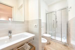 a white bathroom with a sink and a shower at La Corallina in Santa Margherita Ligure