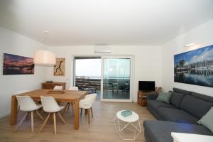 a living room with a table and a couch at Casa MICHI in Dervio