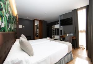 Posteľ alebo postele v izbe v ubytovaní Málaga Premium Hotel