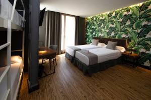 Posteľ alebo postele v izbe v ubytovaní Málaga Premium Hotel