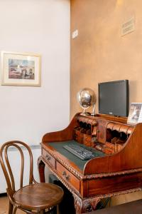 a wooden desk with a piano and a television at Hotel Niky in Sofia