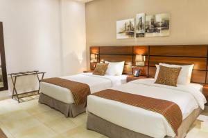 Cama o camas de una habitación en Q Suites Jeddah by EWA - Managed by HMH