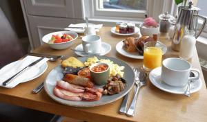 a table with a plate of breakfast food on it at The Dean Court in York