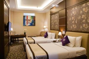 Katil atau katil-katil dalam bilik di Adhiwangsa Hotel