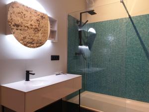 a bathroom with a sink and a glass shower at Brunnenschmiede in Konstanz