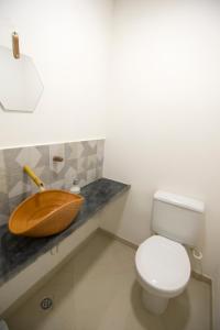 a bathroom with a wooden sink and a toilet at Mar à Vista Hostel in Salvador