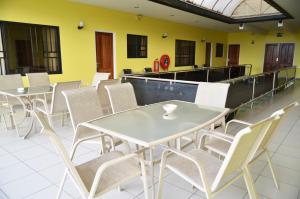 a row of tables and chairs in a restaurant at Rachel's Apartments in Paramaribo