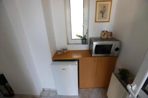 a small kitchen with a microwave and a counter at INSPIRATION Guestroom with Amazing Roof Garden in Athens +18 photos