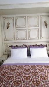 a bedroom with a large bed with two pillows at Losta Sahil Evi 2 in Selimiye