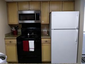 a kitchen with a white refrigerator and a microwave at Bayou Beauty in Ocean Springs