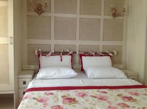 a bedroom with a bed with two pillows at Losta Sahil Evi 2 in Selimiye