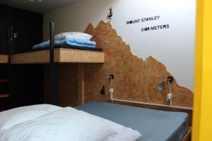 a room with a bed and a wall with a painting on it at Globalhagen Hostel in Copenhagen