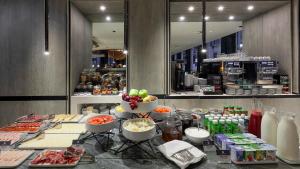 a kitchen counter filled with lots of food at Porto Royal Bridges Hotel in Porto