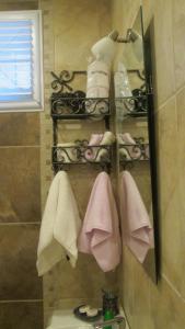 a bathroom with a rack of towels and shoes at Losta Sahil Evi 2 in Selimiye
