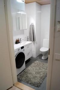a bathroom with a sink and a washing machine at Studio in Trendy Kakola Hill area close to city center in Turku