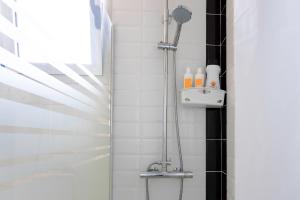 a shower with a shower head in a bathroom at Almar Apartamento con AC, Los Cristianos in Los Cristianos +46 photos
