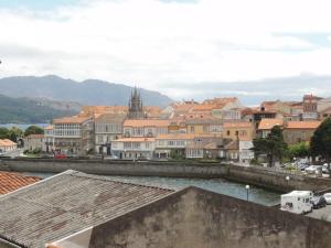 a view of a city with a river and buildings at Casa Lourdes in Corcubión