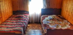 a bedroom with two twin beds in a room at Guest House Buba in Ushguli
