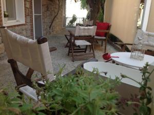 a patio with chairs and a table with a plant at Losta Sahil Evi 2 in Selimiye