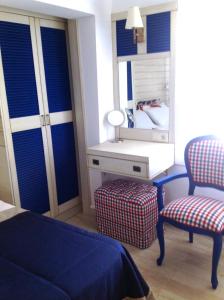 a bedroom with a bed and a mirror and a chair at Losta Sahil Evi 2 in Selimiye