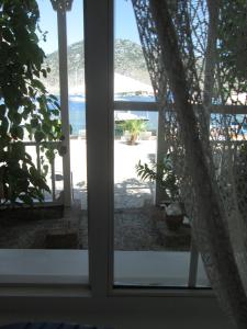 a view of the beach from a window at Losta Sahil Evi 2 in Selimiye