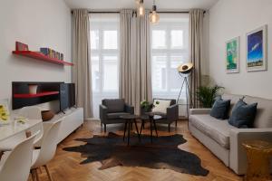 a living room with a couch and a table at Residence Vocelova in Prague