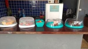 a counter with four bowls on top at Pousada Villa Calango in Canoa Quebrada