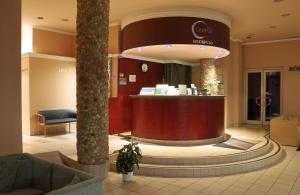 a hotel lobby with a counter in the middle at Hotel Centrál in Nagykanizsa
