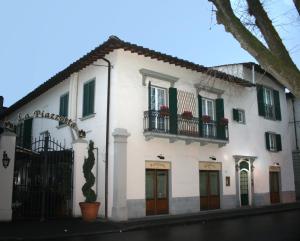 a white building with green shutters on a street at JOIVY Together Florence Secret Nest in Florence