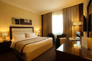 a hotel room with a bed and a window at Lancaster Raouche Hotel in Beirut