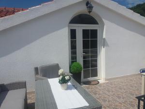 a patio with a door and a table with a plant at Maja's Place Apartments in Korčula