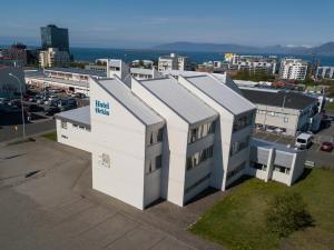 a white building with a blue sign on the side of it at Hotel Orkin in Reykjav&iacute;k