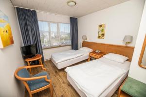 Un pat sau paturi într-o cameră la Hotel Orkin