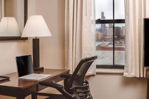 a living room with a chair and a lamp at Chicago South Loop Hotel in Chicago