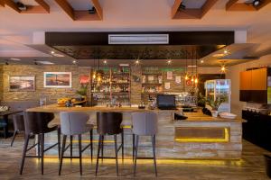 a bar in a restaurant with bar stools at Le Marc Guest house in Budva