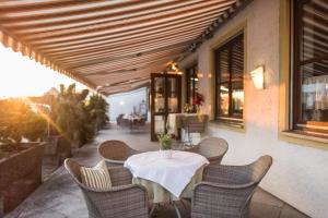 a table and chairs sitting on a patio at Hotel Ariadne in Rosenheim