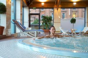 a woman in a hot tub in a hotel room at Glasgow Argyle Hotel, BW Signature Collection in Glasgow +62 photos
