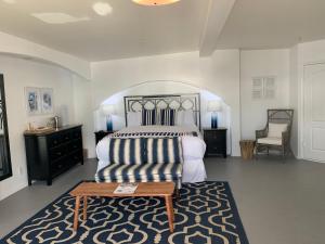 a bedroom with a bed and a table in it at Casa Tropicana in San Clemente