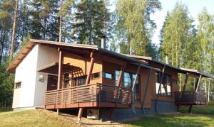 a house with a wrap around deck on a hill at Saimaa Style Spa Chalet in Imatra