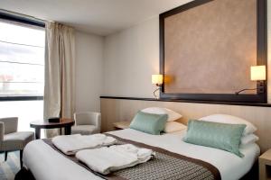 Postel nebo postele na pokoji v ubytování Mercure Vichy Thermalia + 37 fotografií