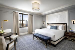 a hotel room with a large bed and a large window at Fairmont Royal York Gold Experience in Toronto